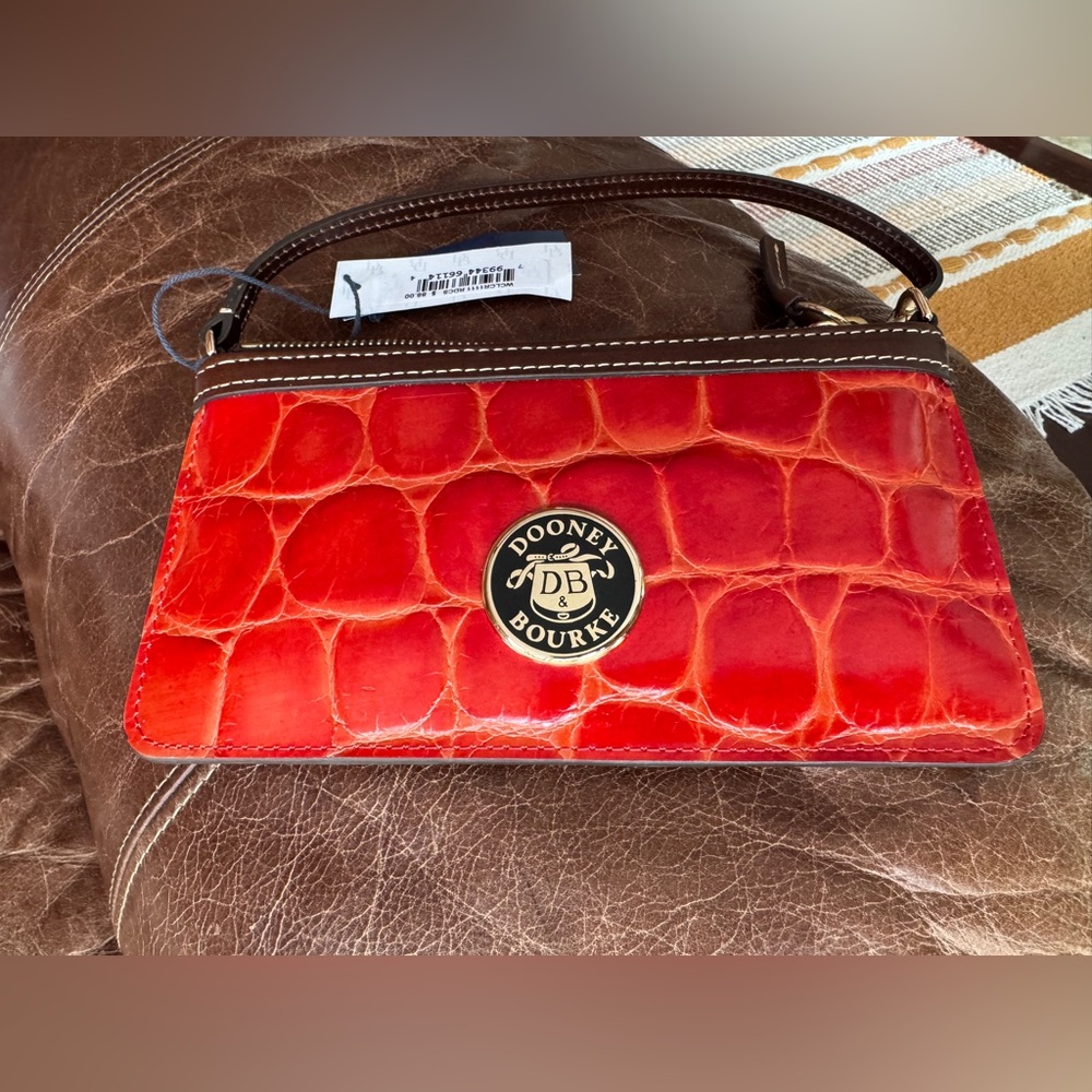 Dooney & Bourke Zip Wristlet in dark red/burnt orange